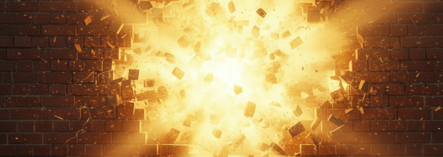 A brick wall exploding from the center with bright golden light and flying debris.